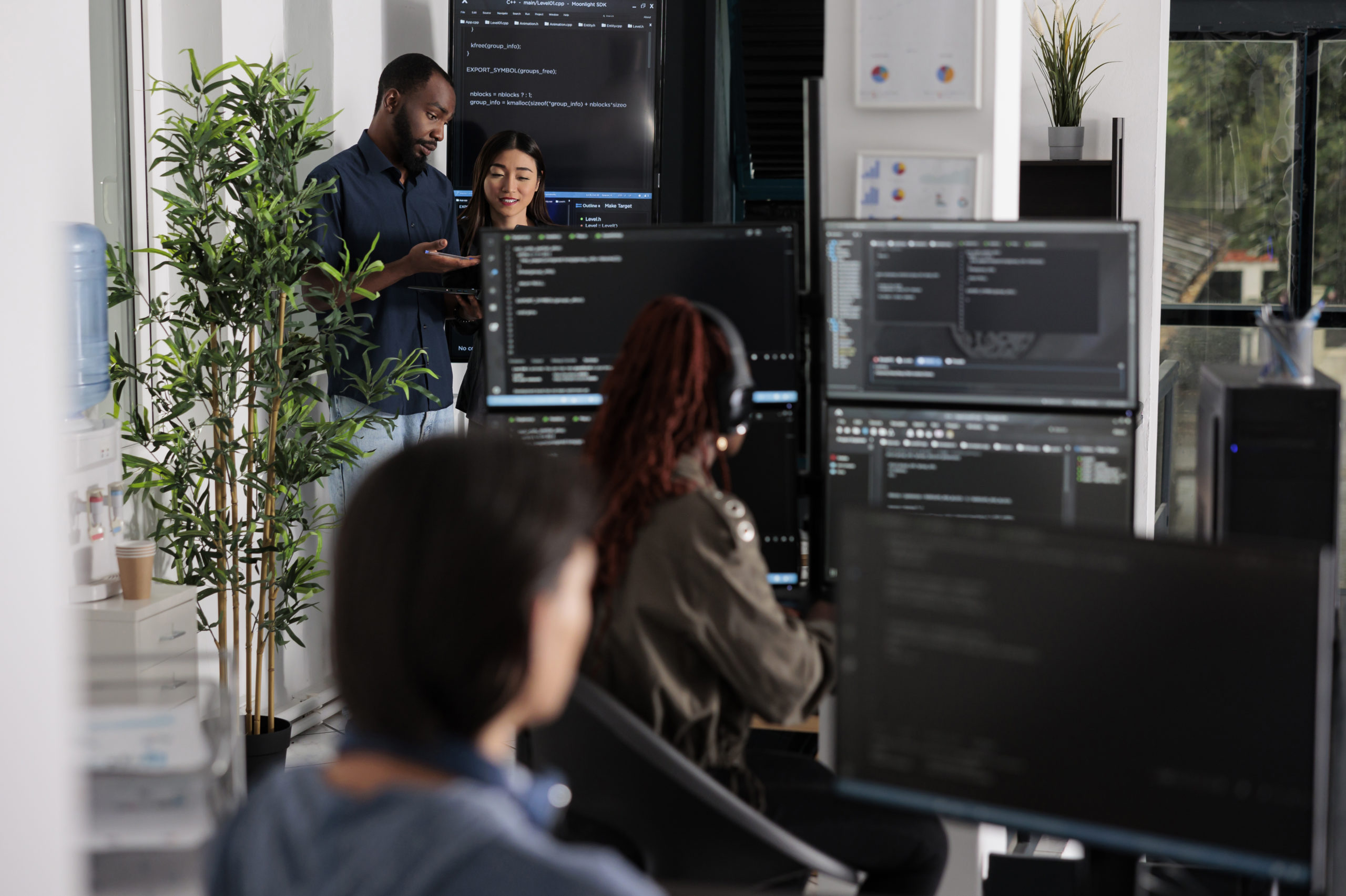 Software programmers discussing about algorithms on big screen