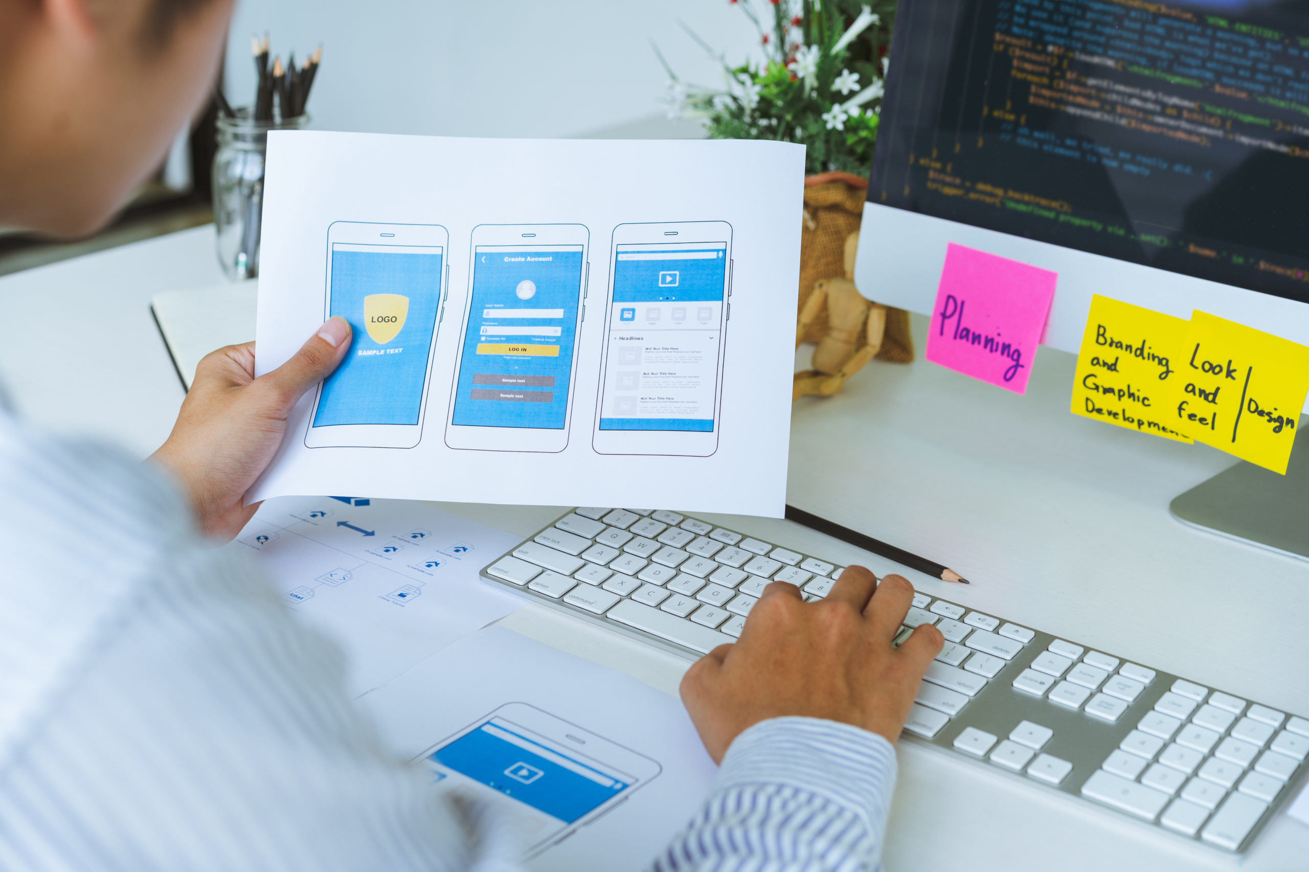 Cropped shot of startup UX UI front end designers developing programming and coding responsive web content or mobile application from prototype and wireframe layout.